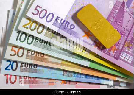 euros and gold bar Stock Photo