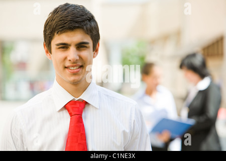 Portrait of handsome employer smiling at camera in working environment Stock Photo