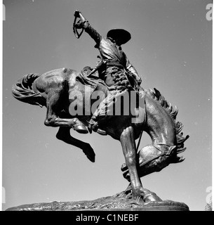 America, 1950s. View from below of the bronze statue of the famous Indian hunter Buffalo Bill on his Bucking Bronco, Denver. Stock Photo