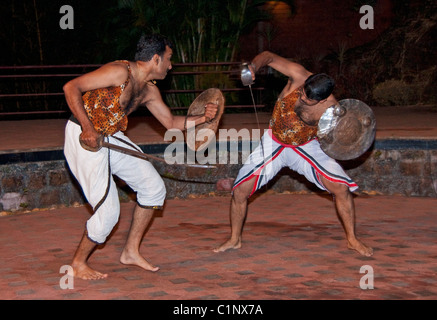 Kalaripayattu, or Kalari martial art of Kerala, with combatants using swords and shields in Calicut performance Stock Photo