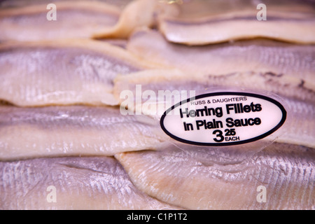 Herring Fillets in various sauces, Russ & Daughters, New York City.  179 East Houston Street, NY, NY 10002, Appetizers Stock Photo