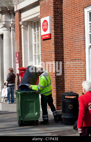 street cleaner emptying bins in Chichester City Centre Stock Photo