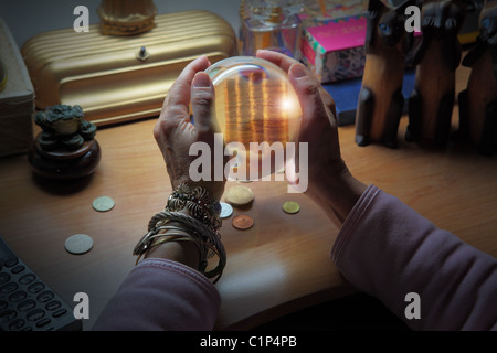 woman's hands holding crystal ball and divining a prosperous future Stock Photo