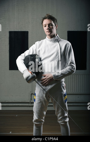 Portrait of male fencer in sports hall Stock Photo