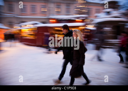 Couple walking through city Stock Photo