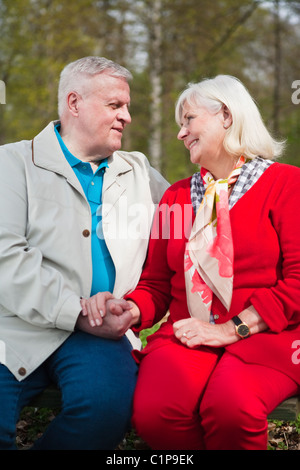 Senior couple sitting in park Stock Photo