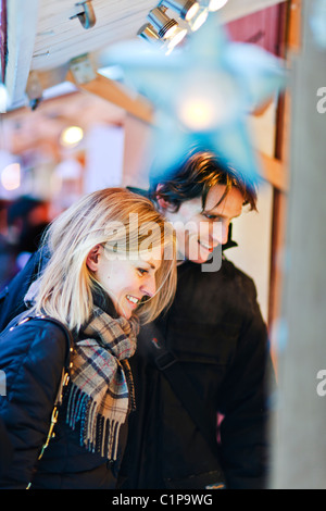 Couple standing in front of stall Stock Photo