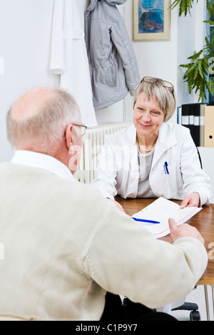 Doctor and patient talking in clinic Stock Photo