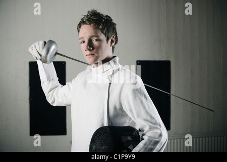 Portrait of male fencer in sports hall Stock Photo