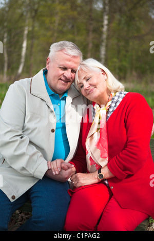 Senior couple sitting in park Stock Photo