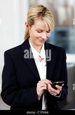 Businesswoman using smart phone Stock Photo