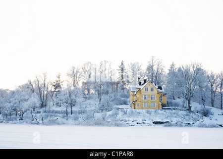 House in snowy landscape Stock Photo