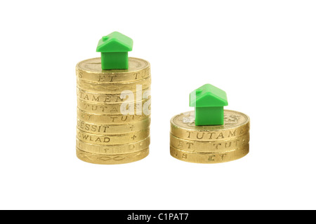 Property Market, pound coins with monopoly houses on top Stock Photo