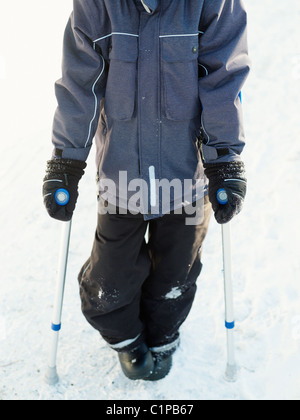 Boy walking with crutch Stock Photo