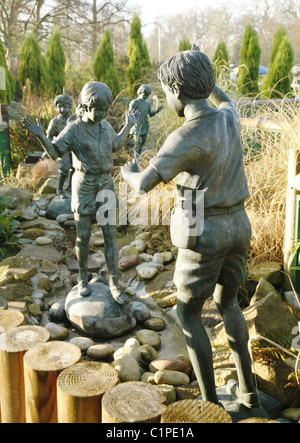 Statues of children playing, at the Paradise Wildlife Park. Dedicated to the Great Ormond Street Hospital for Sick children. Stock Photo