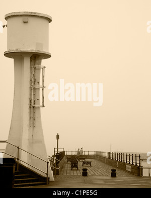 Littlehampton Lighthouse and Pier on a Misty Day in Sepia Stock Photo