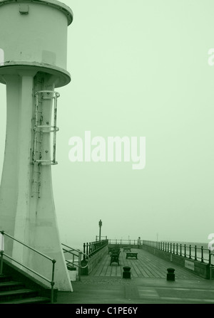 Littlehampton Lighthouse and Pier on a Misty Day in Sepia Stock Photo