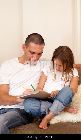 Father and daughter sitting on the couch Stock Photo