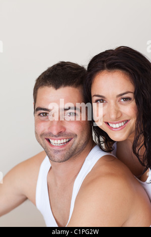 Positive young couple sitting on the bed Stock Photo