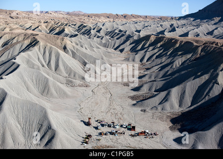 AERIAL VIEW. Junk yard in a desert landscape of badlands. Caineville, Southern Utah, USA. Stock Photo