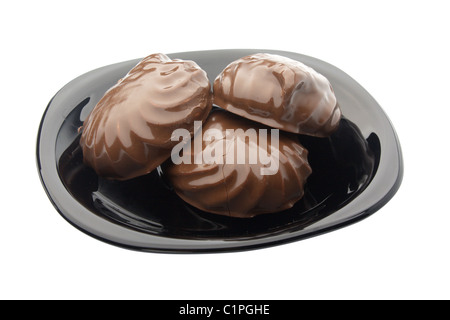 three cookie in chocolate on black plate isolated on white Stock Photo