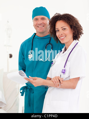 Friendly nurse with handsome surgeon in blue scrubs Stock Photo