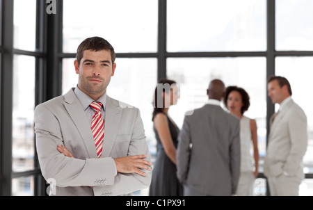 Attractive confident male manager leading his team Stock Photo - Alamy