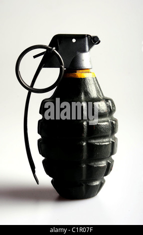 A fregmentation grenade under harsh side lighting to emphasize its shape and contours. Stock Photo