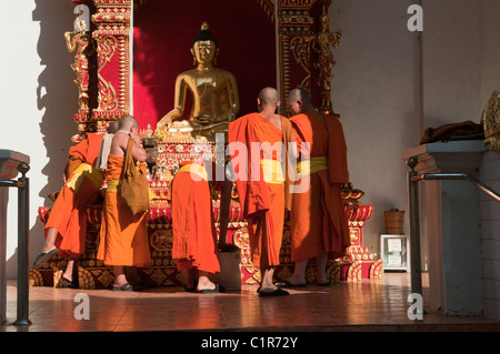 monks praying at Wat Phra Singh Temple in Chiang Mai, Thailand Stock Photo