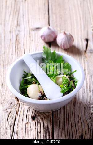 Mortar and pestle with ingredients ready to be ground Stock Photo