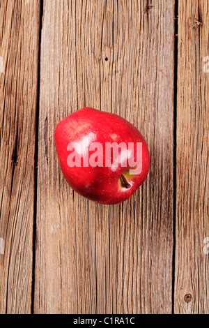 Shiny red apple on wood - overhead Stock Photo