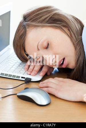 Young businesswoman sleeping on the keyboard Stock Photo