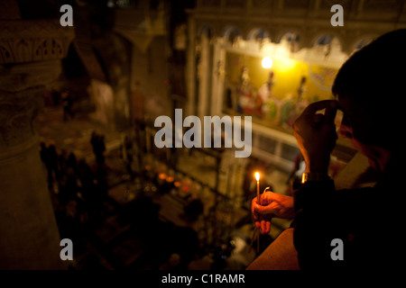 Lighting devotional candles at Calvary, Church of Holy Sepulcher Jerusalem. Stock Photo