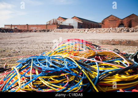 Copper wire stripped by thieves for scrap value, on waste ground in Barrow in Furness, Cumbria. Stock Photo