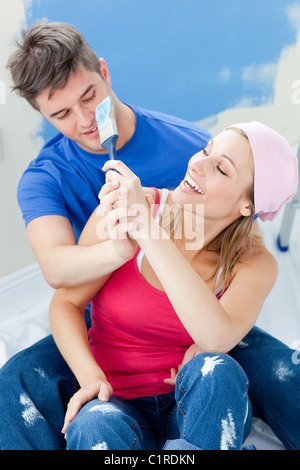 Happy couple painting a room Stock Photo