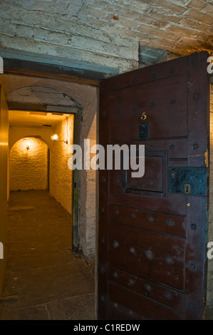 View from a prison cell down a gaslit passage in the basement at the Judge's Lodging, Presteigne, Powys, an award winning museum of Victorian life Stock Photo