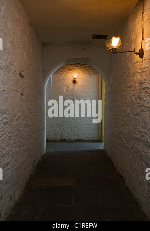 View from a prison cell down a gaslit passage in the basement at the Judge's Lodging, Presteigne, Powys, an award winning museum of Victorian life Stock Photo