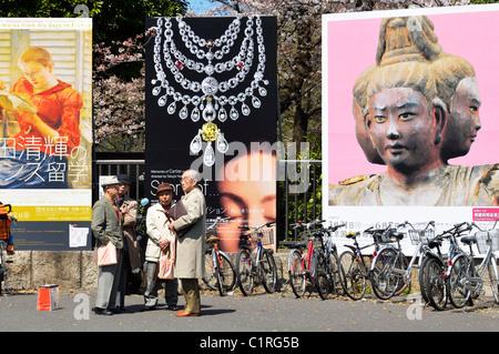 Japanese elderly men standing in front of a billboard at Tokyo National Museum, Tokyo Ueno, Japan JP Stock Photo