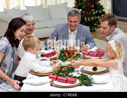 Children pulling a Christmas cracker at home Stock Photo
