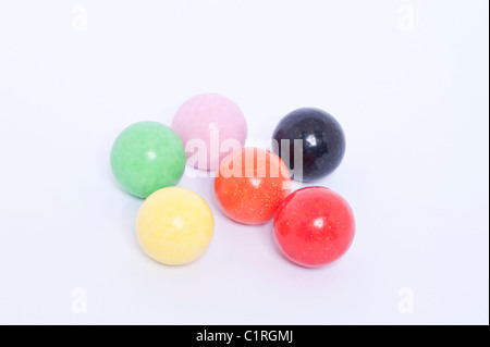 A selection of coloured gobstoppers traditional sweets on a white background
