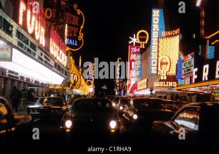 Las Vegas strip vintage 1960s 1970s photo of Mint Horseshoe Binions casino sign gambling casinos, nightclubs, neon signs, cars in traffic at night Nevada USA   1971  KATHY DEWITT Stock Photo
