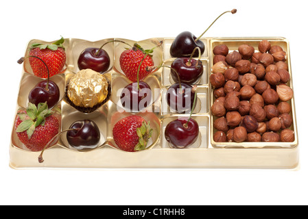 Sweet cherries strawberries nuts hazelnut and sweetmeat in plastic form Stock Photo