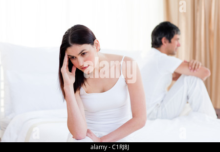 Angry couple having an argument sitting on bed Stock Photo