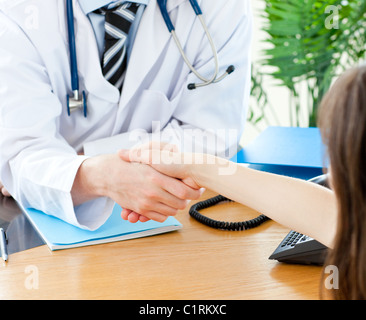 Self-assured doctor with his upset patient Stock Photo