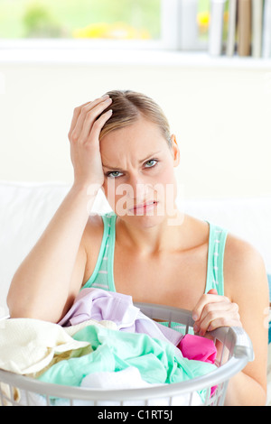 Exhausted young woman doing the laundry Stock Photo