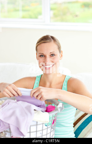 Cheerful young woman doing the laundry Stock Photo