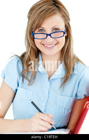 Ambitious businesswoman taking notes smiling at the camera Stock Photo