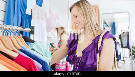 Elegant young woman choosing clothes with her friend Stock Photo
