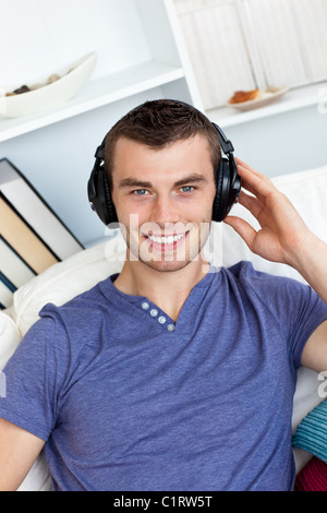 Smiing caucasian man listen to music with headphones Stock Photo