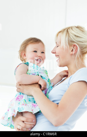 Smiling woman playing with her daughter Stock Photo
